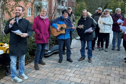Menschen stehen bei der Eröffnung des Stutenteichparks in einem Halbrund, einer spielt Gitarre.