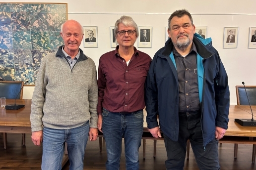 Drei Männer stehen im Ratssaal der Stadt Waltrop. 