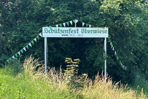 Ein Banner im Grünen weist hin auf das Schützenfest in Oberwiese.